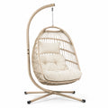 Poltrona sospesa in rattan sintetico con cuscini in poliestere, struttura in acciaio, crema